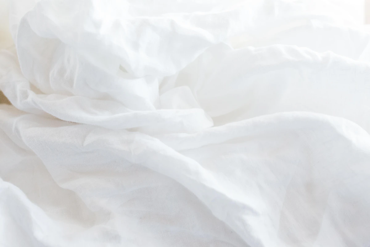 Crisp white bed linens, freshly made